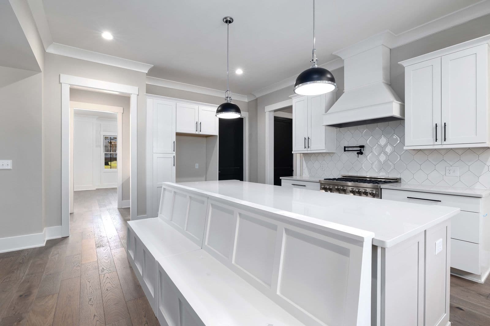 Bright modern white kitchen with built-in appliances